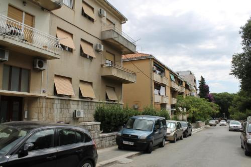 a street with cars parked next to a building at Apartment Devivi Adris in Split