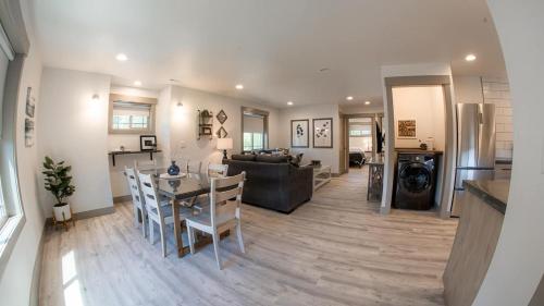 a kitchen and living room with a table and chairs at The Raspberry Garden Luxury Hotel & Suites in Rexburg