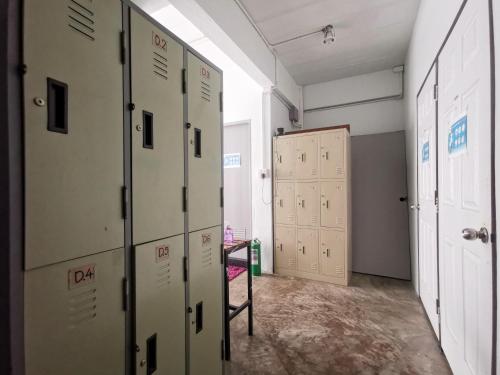a room with lockers and a room with a door at Asleep Hostel in Kanchanaburi