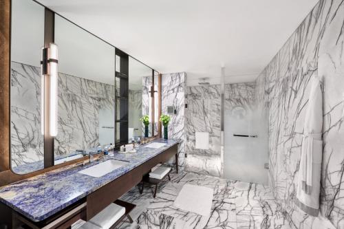 uma casa de banho com 2 lavatórios e um espelho grande em City of Dreams Macau - Nüwa Macau em Macau