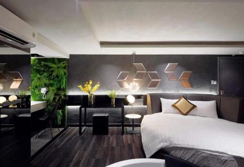 a bedroom with a bed and a desk in it at Bonita Signature Hotel in Ho Chi Minh City