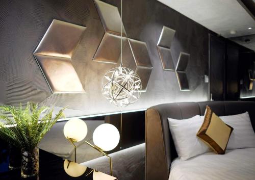 a bedroom with a bed and lights on the wall at Bonita Signature Hotel in Ho Chi Minh City