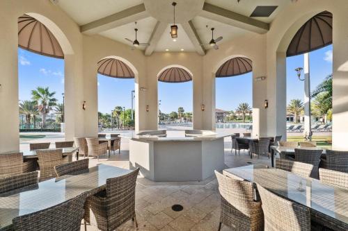 a lobby of a resort with tables and chairs at 1542MVD-The Retreat at Champions Gate in Davenport