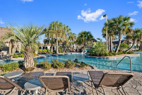 a pool at a resort with chairs and a fountain at 1542MVD-The Retreat at Champions Gate in Davenport