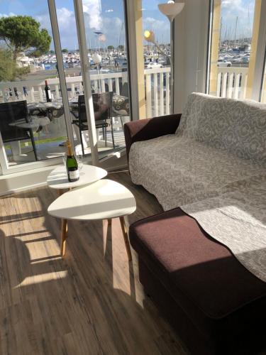 ein Wohnzimmer mit einem Sofa und einem Tisch in der Unterkunft T3 NEUF VUE PANORAMIQUE sur Mer PREMIERE LIGNE in Arcachon