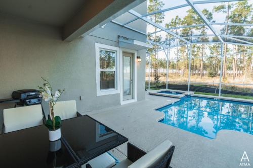 uma piscina numa casa com tecto de vidro em 8975BSW - The Retreat at ChampionsGate em Davenport