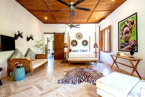 a living room with a ceiling fan and a zebra rug at Villa Pulau Cinta Boutique Suites in Gili Meno