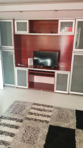 a living room with a flat screen tv on a wall at Apartament B Orizont in Bacău