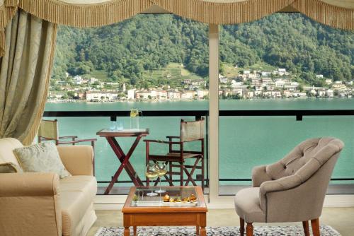 a living room with a view of the water at Swiss Diamond Hotel & Spa in Morcote