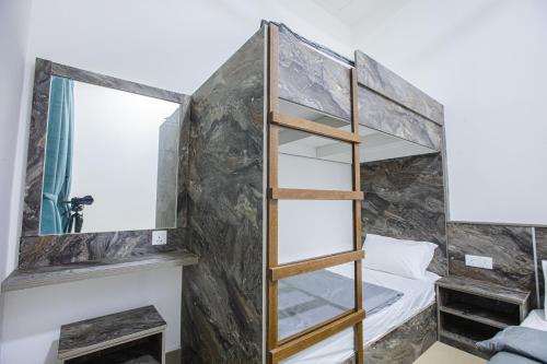 a bedroom with a bunk bed and a mirror at Barrington Villa @ Golden Hill in Cameron Highlands