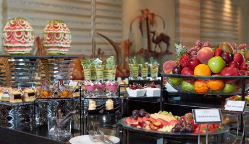 a buffet with many different types of fruits and desserts at Millennium Hotel & Convention Centre Kuwait in Kuwait