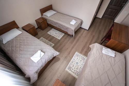 an overhead view of a bedroom with two beds at Muras Hotel Karakol in Karakol