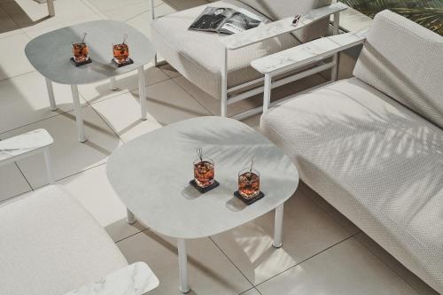 two tables with food on top of them next to a couch at Bluesun hotel Berulia in Brela