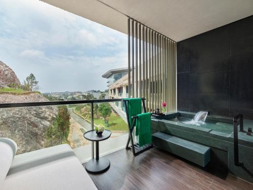 a room with a tub with a view of a mountain at Banyan Tree Nanjing Garden Expo in Nanjing