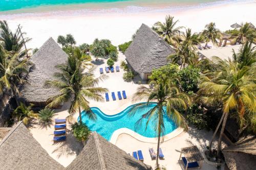 an aerial view of a resort with a swimming pool and the beach at Marafiki Beach Hotel & SPA in Matemwe