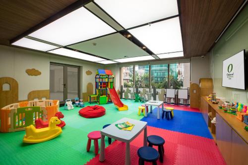 a room with a play area with toys and tables at Oakwood Residence Hanoi in Hanoi