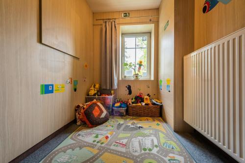 a childs room with a rug on the floor at Penzion 103 in Železná Ruda