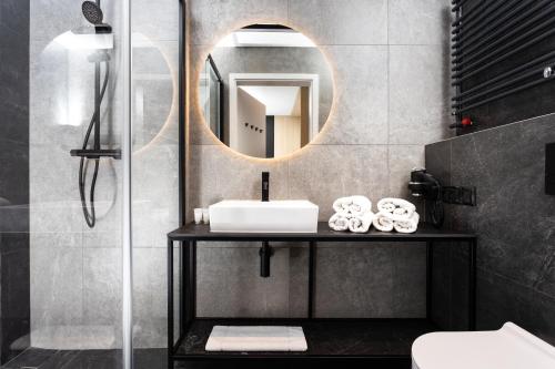 a bathroom with a sink and a mirror at InPoint Apartments G13 near Old Town & Kazimierz in Krakow