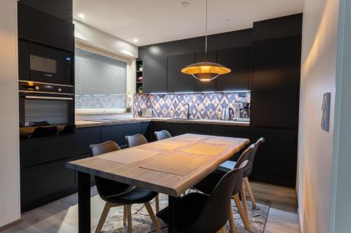 a kitchen with a wooden table and chairs at Apartment Rovakatu B12 in Rovaniemi