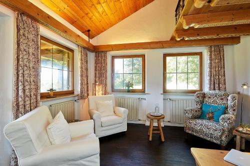 a living room with two chairs and a table at Haus Waldeck in Reit im Winkl