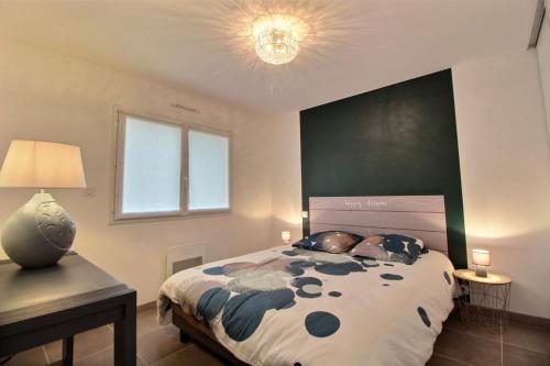 a bedroom with a large bed with a green headboard at Gite de Ker Ravel in Penvénan