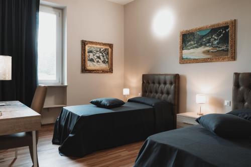 a hotel room with two beds and a window at Valditerra Vini - B&B La Rombetta in  Tassarolo
