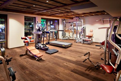 a gym with several exercise equipment in a room at Hotel Neue Post in Mayrhofen