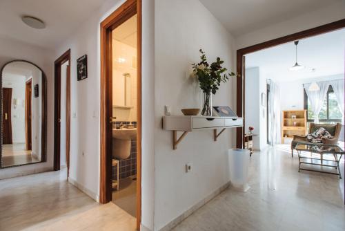 a living room with a hallway with a vase on the wall at Apartamento Mairena in Mairena del Aljarafe