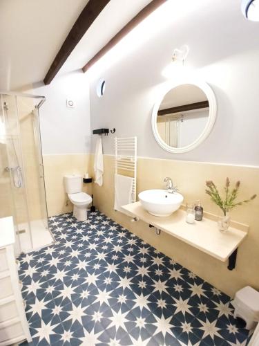 a bathroom with a white sink and a mirror at Apartamentos Minas de Silvarosa in Viveiro