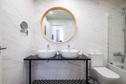 a bathroom with two sinks and a mirror at Soho Boutique Urban in Málaga