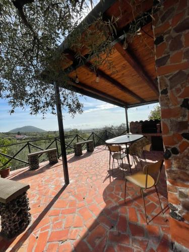 a patio with a table and chairs on a brick patio at ETNA Family in Belpasso