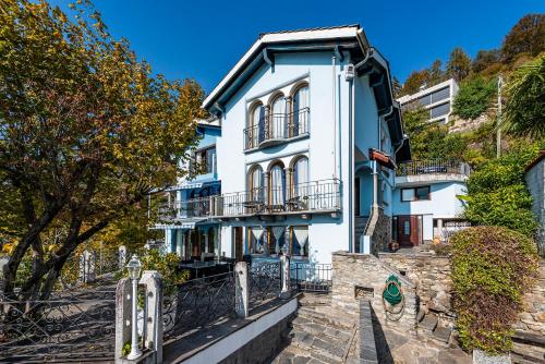 a blue and white building on a hill at Casa Alma Grotto in Brione sopra Minusio