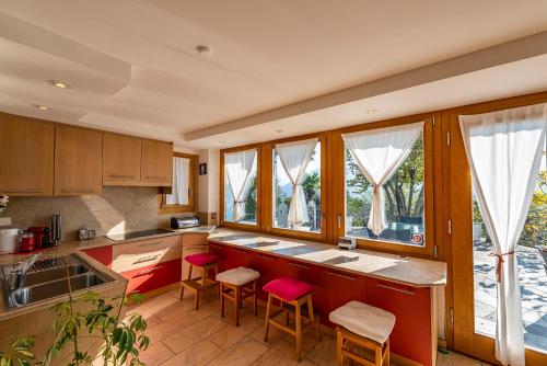 a kitchen with a counter and some windows at Casa ALMA in Brione sopra Minusio