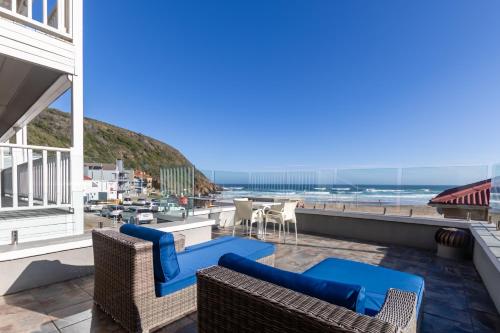 a view of the beach from the balcony of a beach house at Arikreukel 1 and 2 in Herolds Bay