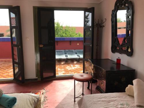 a bedroom with a bed and a dresser and a mirror at Dar el Koutoubia in Marrakech