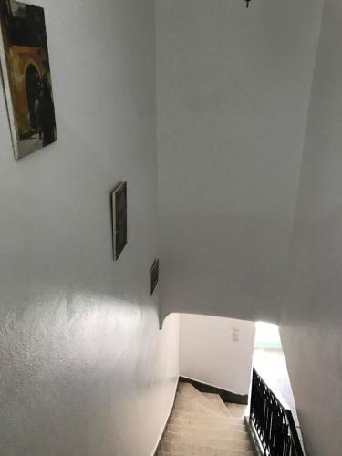 a white room with two pictures on the wall at Dar el Koutoubia in Marrakech