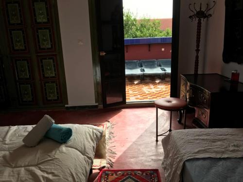 a bedroom with a bed and a view of a patio at Dar el Koutoubia in Marrakech