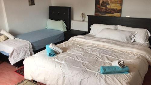 a bedroom with two beds with towels on them at Dar el Koutoubia in Marrakech