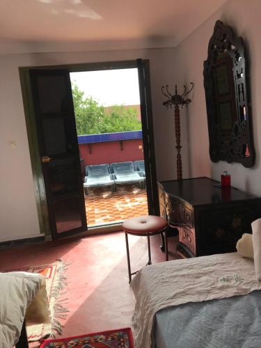 a bedroom with a door open to a patio at Dar el Koutoubia in Marrakech