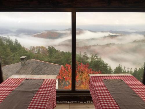 two beds in a room with a view of the mountains at Александрова вила 1 in Zlatograd