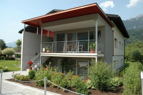 a house with a balcony on a hill at Apartment Bachmann in Bludenz