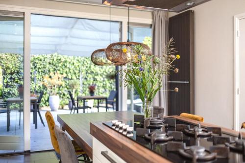 a kitchen with a table and chairs and a dining room at B&B De Mansarde in Apeldoorn