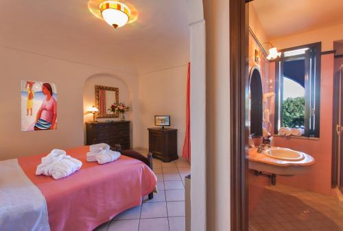 a hotel room with a bed and a sink at Hotel San Valentino Terme in Ischia