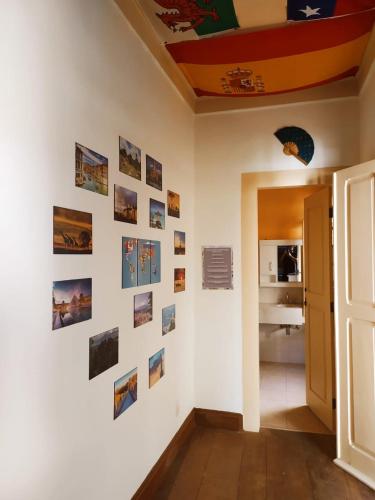 a room with a wall with pictures on it at Del Mundo Hostel in São João del Rei