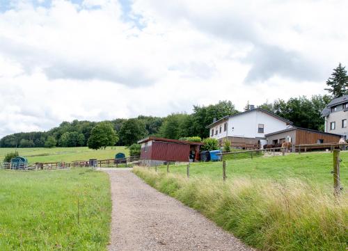 a dirt road in a field next to houses at Ferienwohnung Roderath in Nettersheim