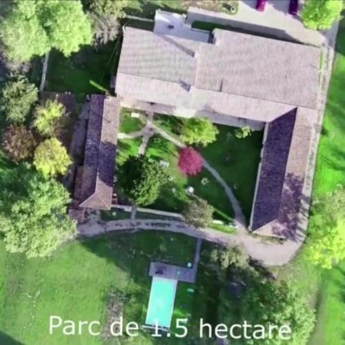an aerial view of a house with a pond at Domaine de Gaïa, Piscine, Pétanque, Ping-pong, proche Saint Emilion in Guillac