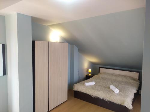 a small bedroom with a bed and a cabinet at Mountain Sunrise in Bansko