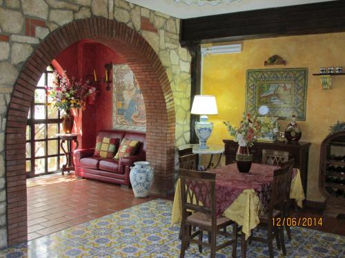 a living room with a table and a couch at Agriturismo Reggia Saracena in Agrigento