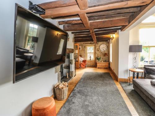 a living room with a flat screen tv on a wall at Belvedere Farm in Halifax