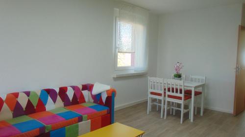 a living room with a couch and a table at Ferienwohnung August 18 in Gelenau